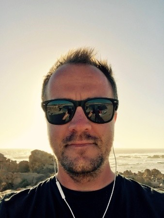 A photo of me by the ocean at sunset
